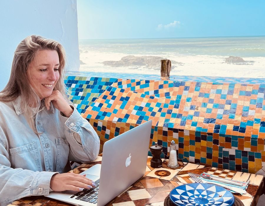 alieke works on laptop by the sea