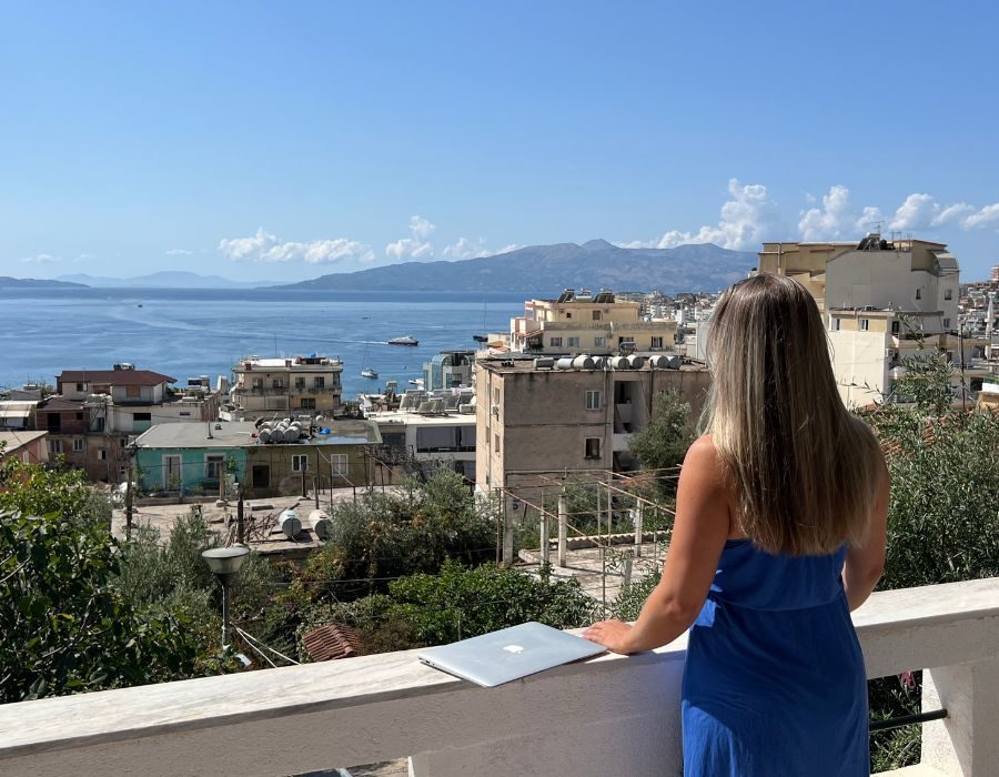 Alieke with her laptop and a view in Albania