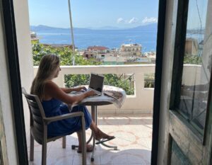 alieke works on her laptop overlooking the sea