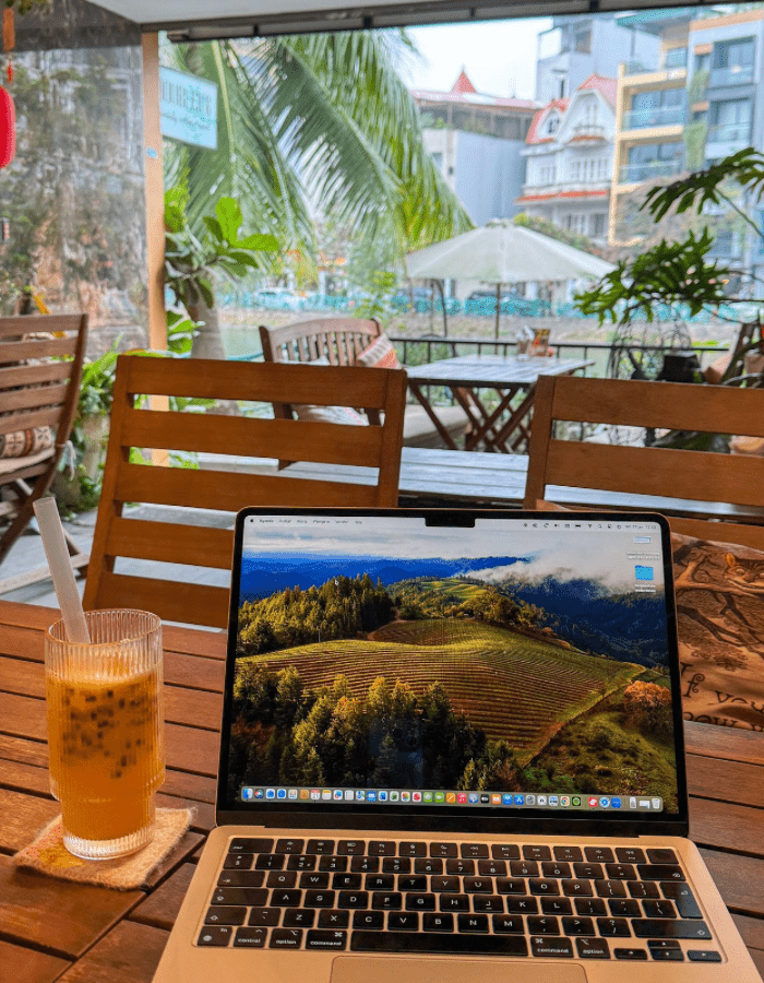 Working on my laptop at a café in Asia, with a healthy juice on the side