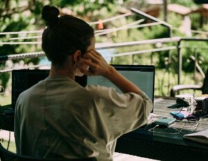 Remote workspace with a laptop and a green background